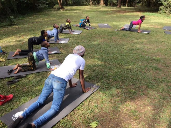 narissa child of the earth teaching yoga in city park nairobi kenya cat pose