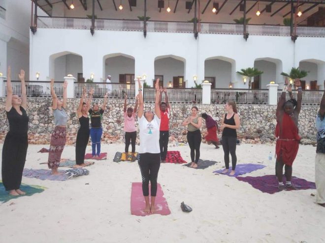 narissa child of the earth teaching beach yoga in Zanzibar